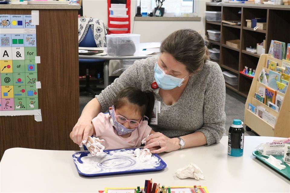 A student works with an Occupational Therapist.